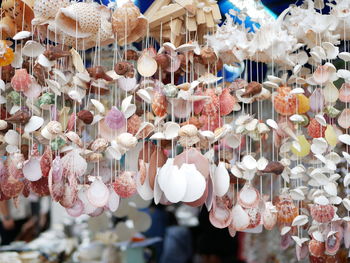 Close-up of decorations hanging in market stall for sale