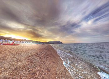 Scenic view of beach against sky during sunset