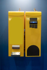 Close-up of yellow mailbox on wall