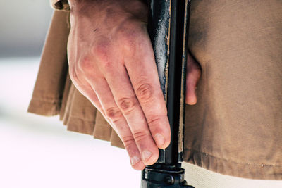 Midsection of woman holding hands against white background