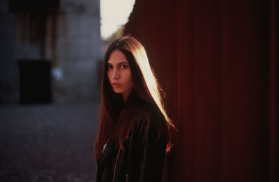 Portrait of beautiful young woman standing outdoors