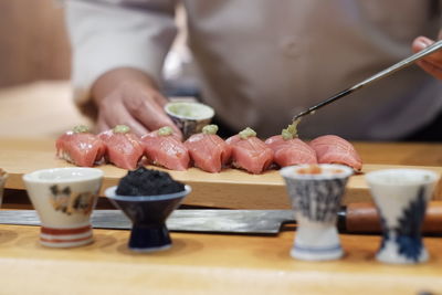 Close-up of person preparing food on table