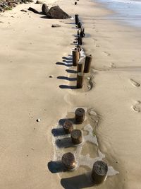 High angle view of wooden posts on beach