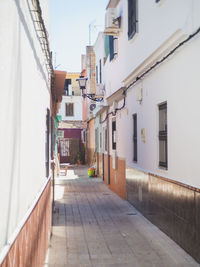 Empty alley amidst buildings in city