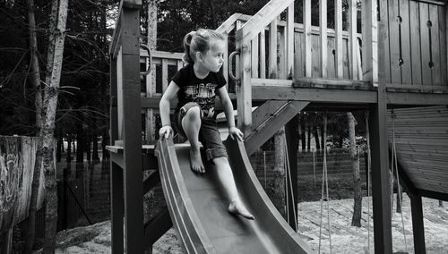 Girl playing on slide at playground