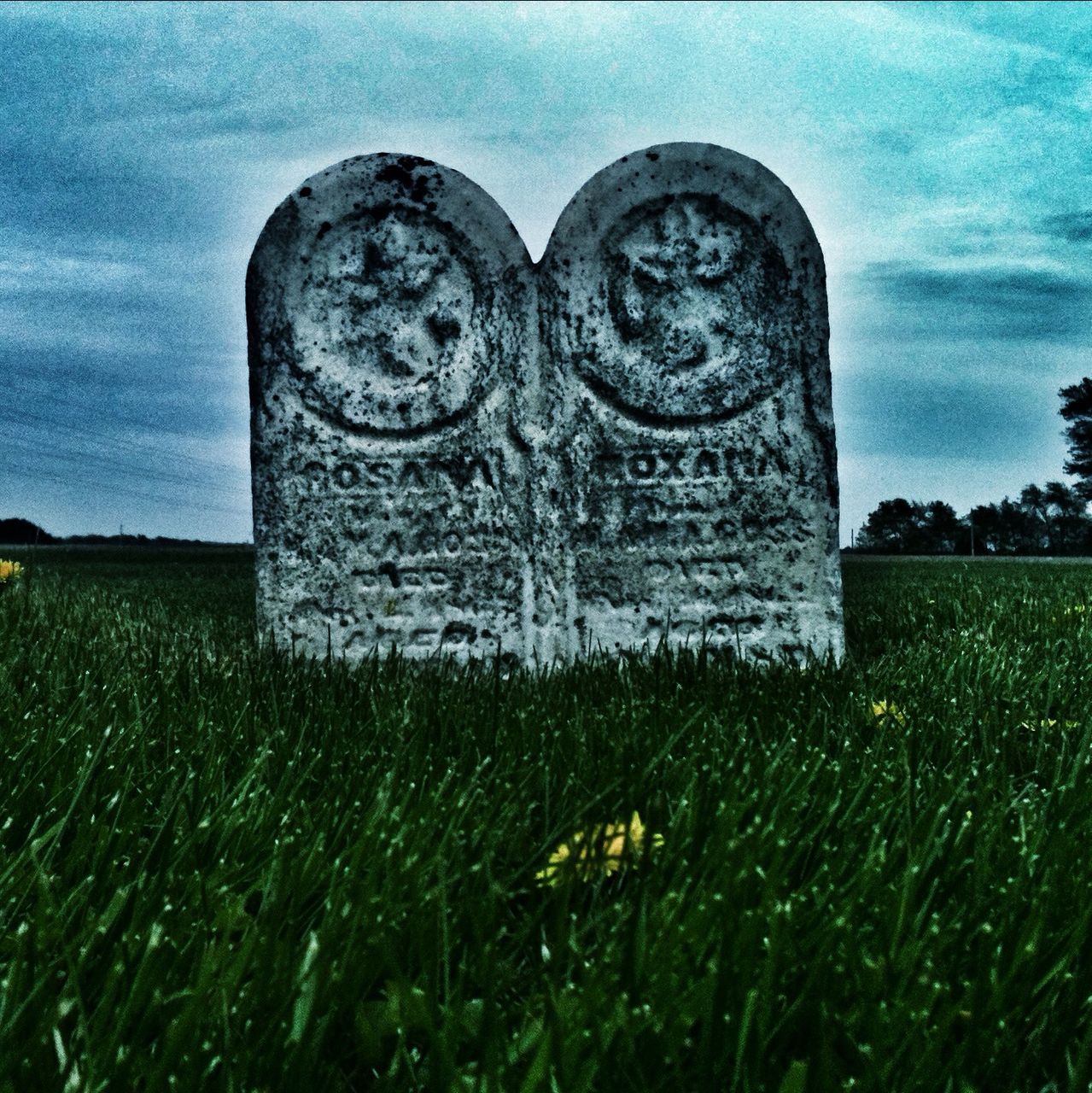 grass, human representation, art, art and craft, statue, sculpture, creativity, field, sky, stone material, green color, history, the past, carving - craft product, grassy, day, outdoors, no people, tranquility