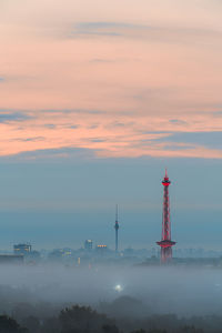 Cityscape against sky at sunset