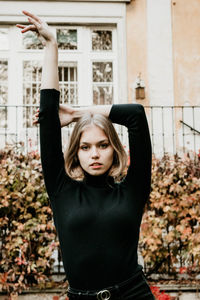 Portrait of young woman standing in park