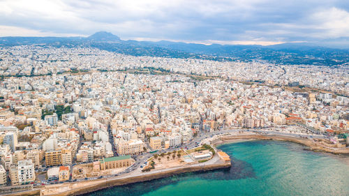 High angle view of city against cloudy sky