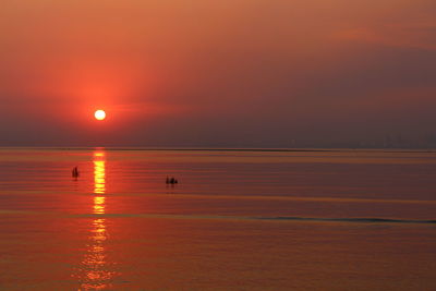 Scenic view of sea against orange sky