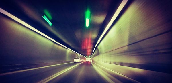 Illuminated tunnel at night