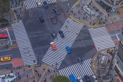 High angle view of vehicles on road along buildings