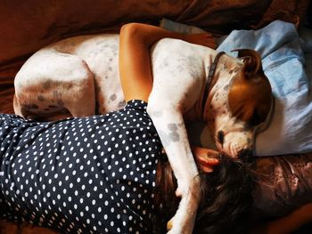 Girl sleeping with dog at home