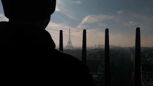 Midsection of man against sky at sunset