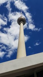 Low angle view of communications tower against sky