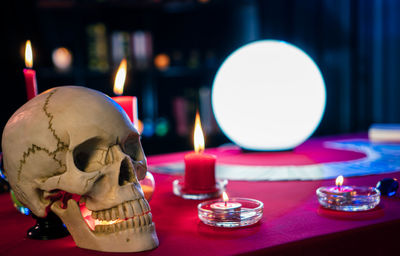 Close-up of lit tea light candles on table