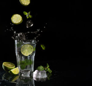 Glass of fruit and drink on table