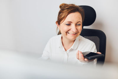 Woman talking on phone using speaker mode. woman recording audio message using voice assistance