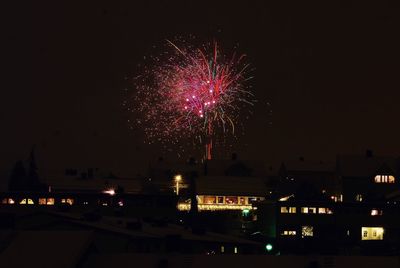 Low angle view of firework display at night
