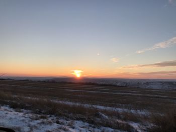 Scenic view of field against sky during sunset