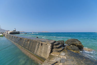 Scenic view of sea against clear blue sky