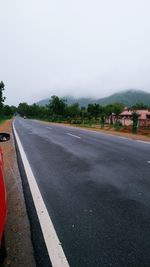 Road by city against sky