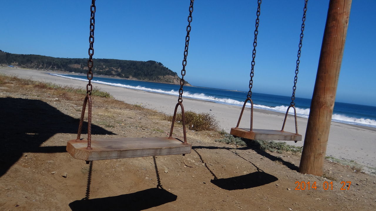 sea, water, beach, tranquility, tranquil scene, clear sky, scenics, sand, horizon over water, beauty in nature, shore, shadow, sunlight, nature, blue, railing, idyllic, mountain, sky, day