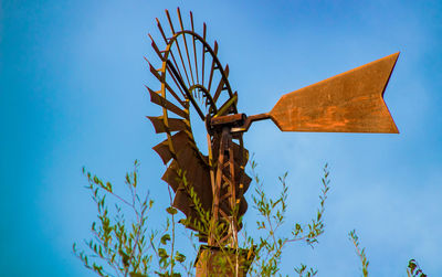 Low angle view of cross against clear blue sky