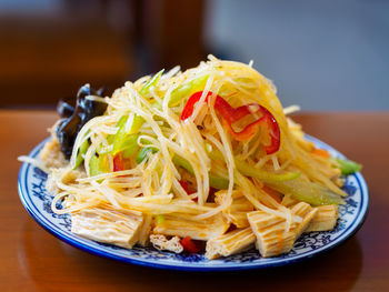 Close-up of noodles served in plate on table