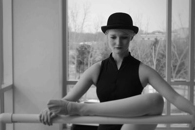 View of ballet dancer exercising against window
