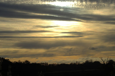 Scenic view of dramatic sky over silhouette landscape
