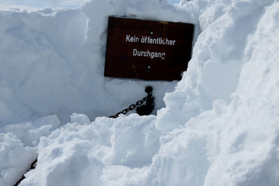 Text on snow covered mountain against sky