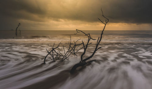 Scenic view of sea against cloudy sky