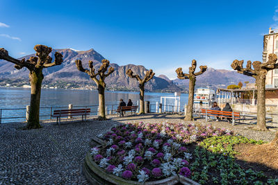 Scenic view of sea and mountains against blue sky