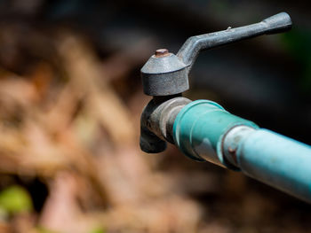 Close-up of water pipe on field