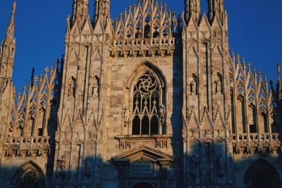 Low angle view of historic cathedral against blue sky