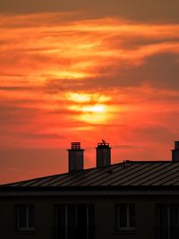 Buildings against sky at sunset