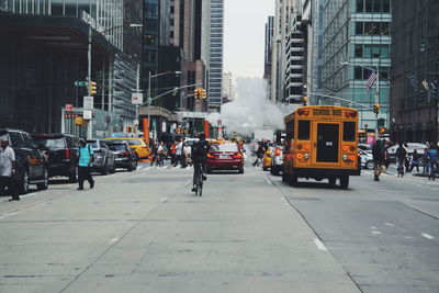 People and vehicles on road in city