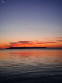 Scenic view of sea against romantic sky at sunset