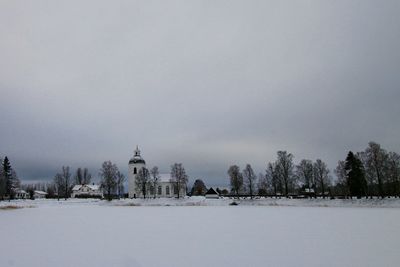 Snow covered landscape against sky
