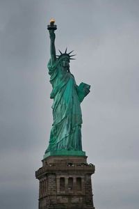 Low angle view of statue of liberty against sky