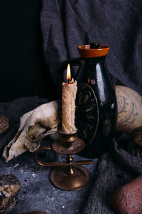 Close-up of burning candles on metal