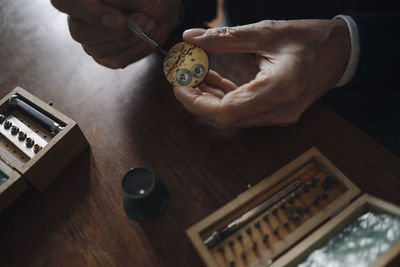 Close-up of senior man repairing a watch