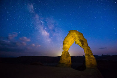 Rock formations against sky at night