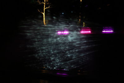 View of illuminated road at night