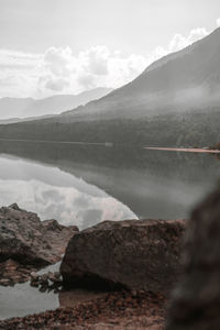 Scenic view of lake and mountains against sky