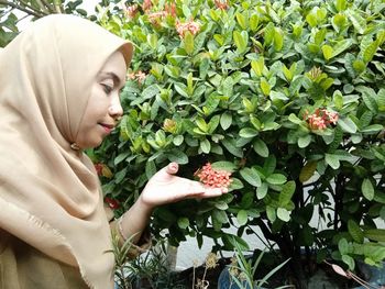 Close-up of woman picking flowers