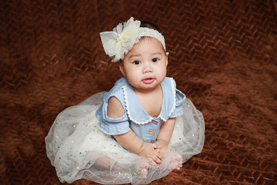 Portrait of cute girl sitting