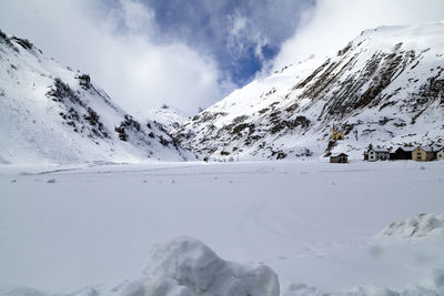 Scenic view of snow covered mountains against sky