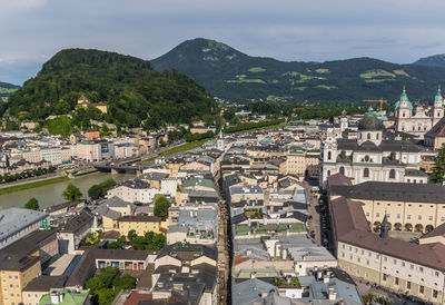 High angle view of townscape and mountains against sky